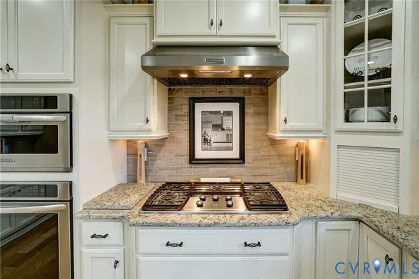 a stove top oven sitting inside of a kitchen