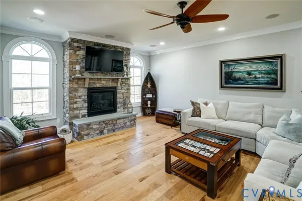 a living room with furniture a flat screen tv and a fireplace