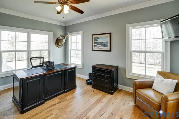 a living room with furniture flat screen tv and a large window