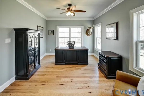 a living room with furniture a rug and a bookshelf