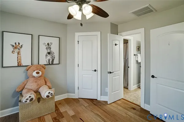 a view of entryway and hall with wooden floor