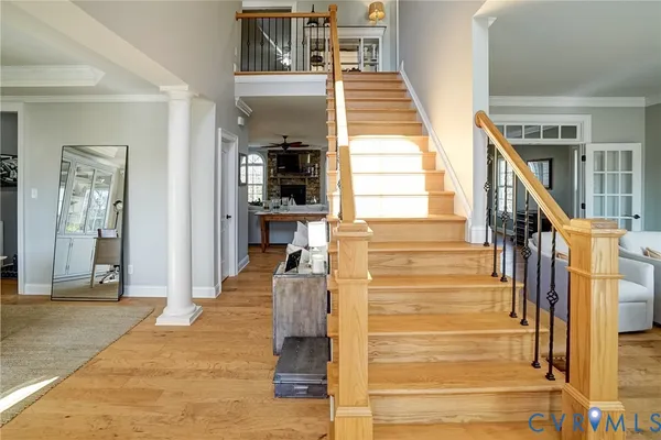 a view of staircase with lots of frames on wall and a window