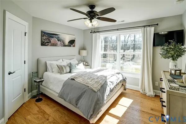 a living room with furniture a wooden floor and a window