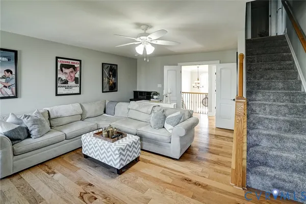 a view of a house with a small yard and a large tree