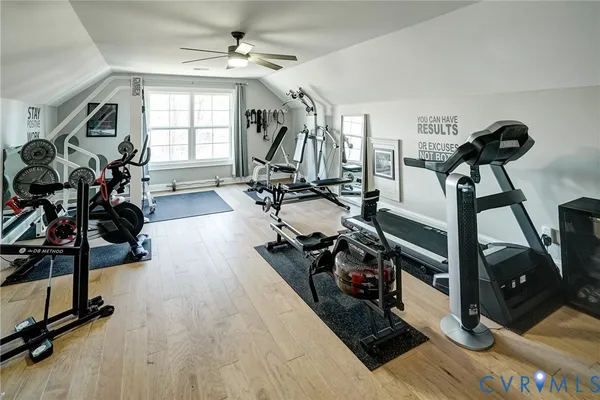 a view of house with a big yard and large trees
