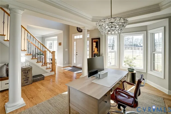 a view of a livingroom with furniture window and wooden floor