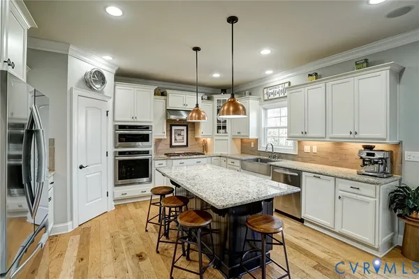 a kitchen with a table chairs refrigerator and stove