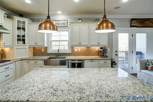 a kitchen with stainless steel appliances a sink a stove a refrigerator and cabinets