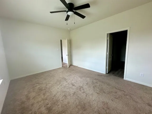 a view of a big room with a ceiling fan