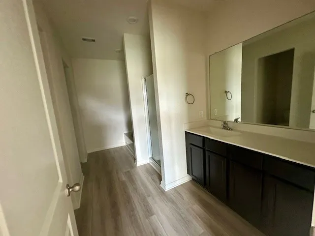 an empty room with windows and ceiling fan