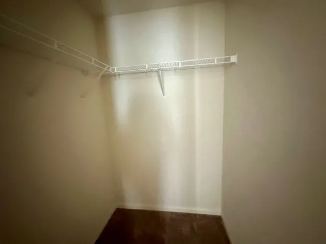 a view of a big room with a ceiling fan