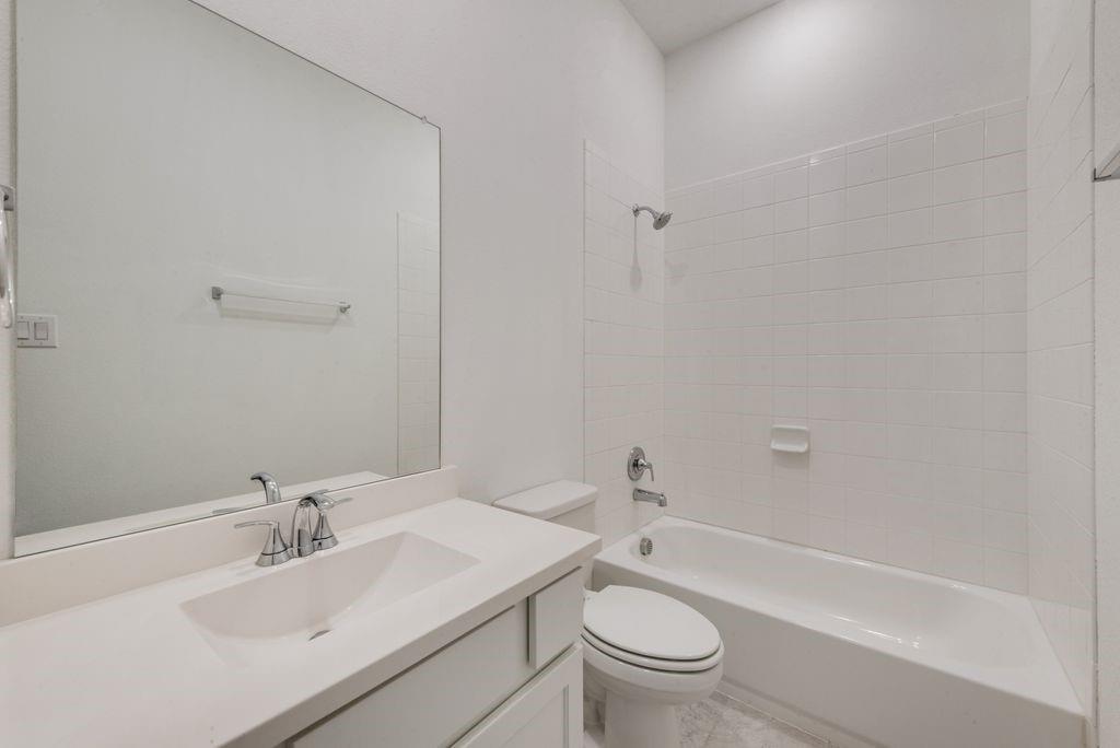 7001 Spring Park Drive Little Elm, TX 76227 - Photo 17 of 38 a bathroom with a sink toilet and shower