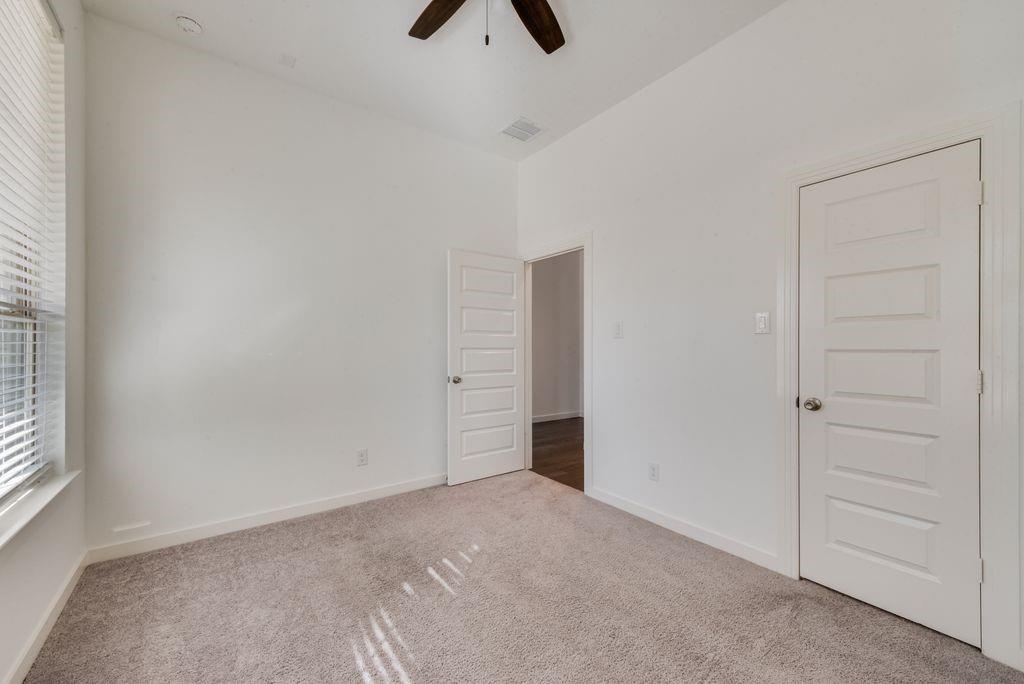7001 Spring Park Drive Little Elm, TX 76227 - Photo 19 of 38 an empty room with closet and windows