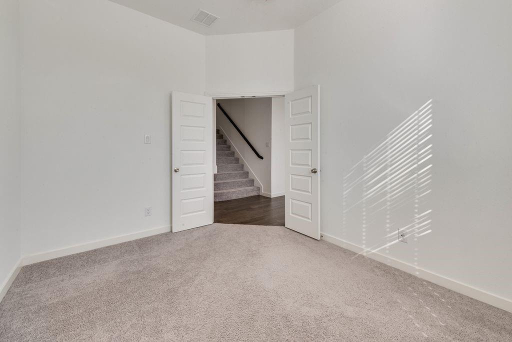 7001 Spring Park Drive Little Elm, TX 76227 - Photo 21 of 38 a view of an empty room with stairs
