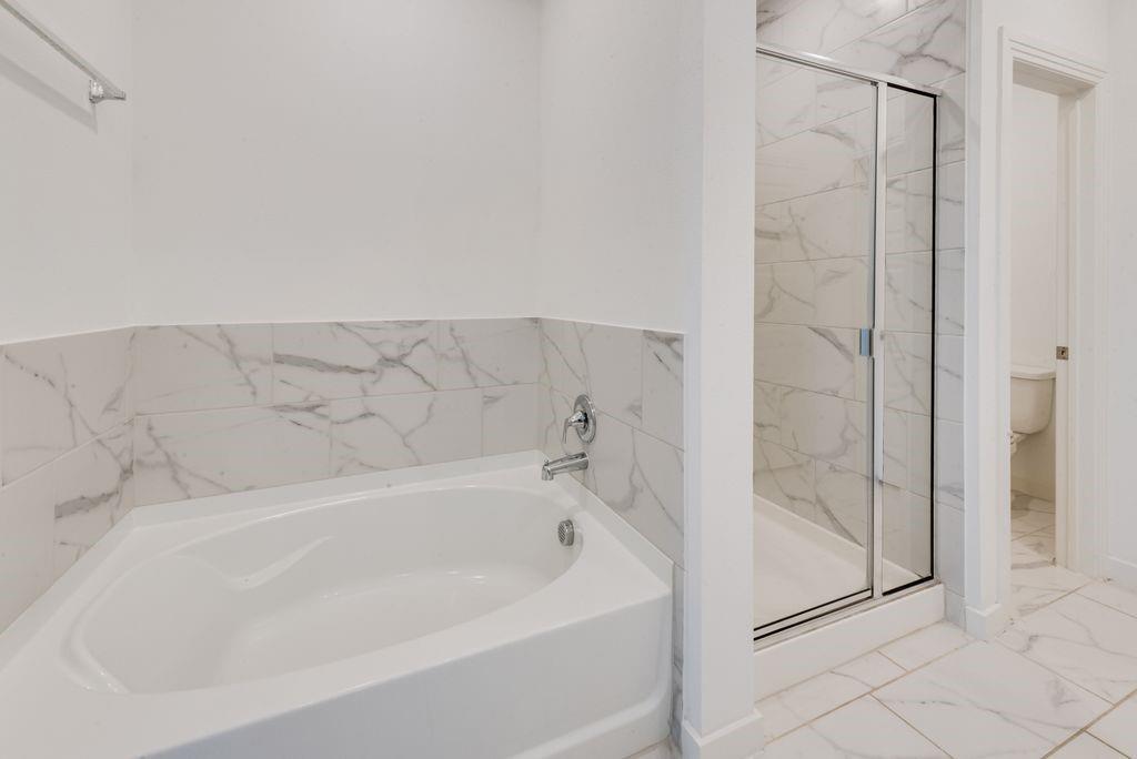 7001 Spring Park Drive Little Elm, TX 76227 - Photo 25 of 38 a bathroom with a bathtub and shower