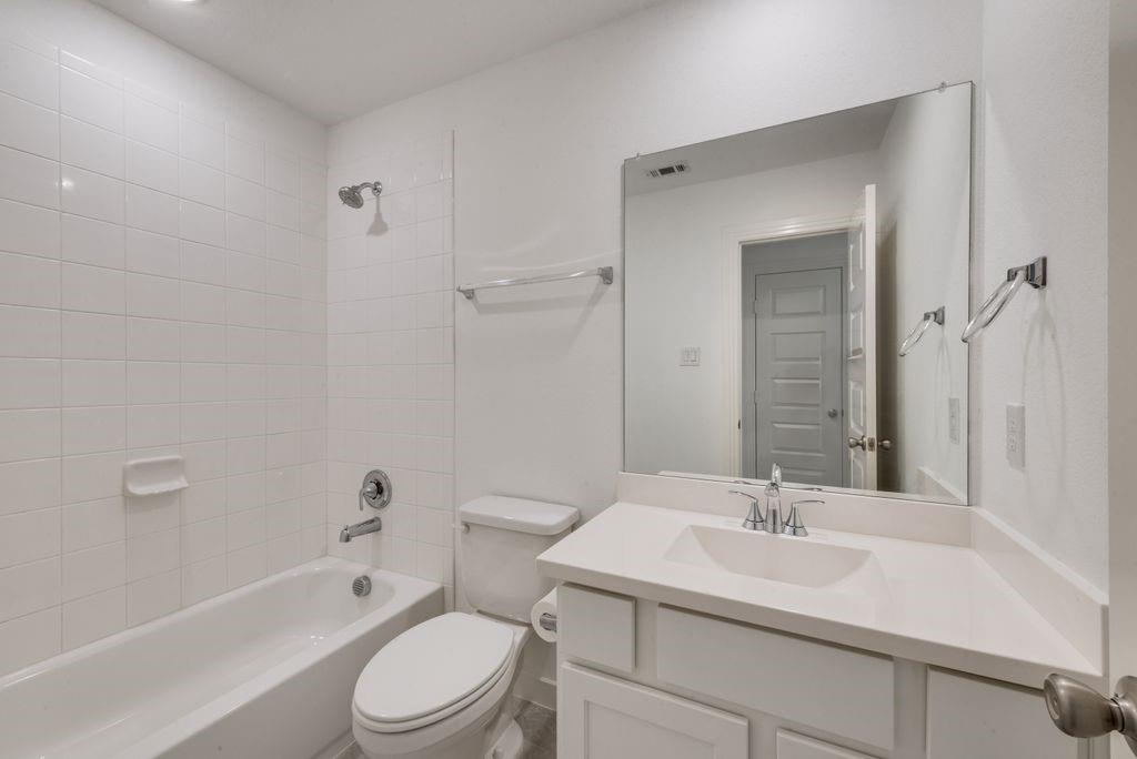 7001 Spring Park Drive Little Elm, TX 76227 - Photo 30 of 38 a bathroom with a sink toilet a mirror and shower