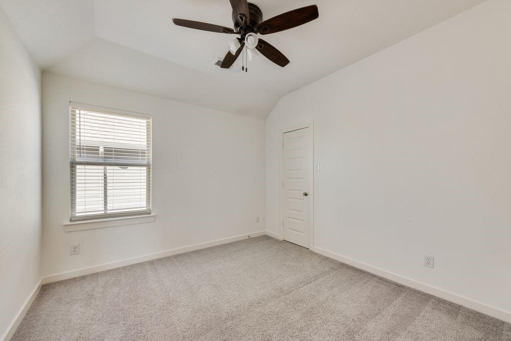 7001 Spring Park Drive Little Elm, TX 76227 - Photo 32 of 38 an empty room with a window and a fan