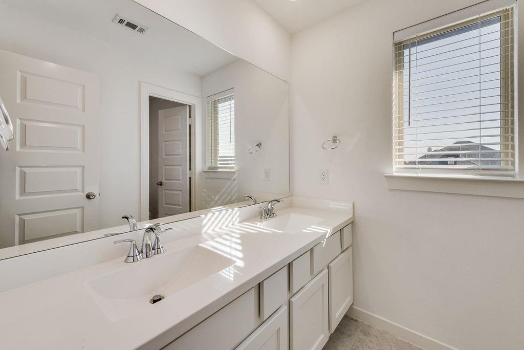 7001 Spring Park Drive Little Elm, TX 76227 - Photo 33 of 38 a bathroom with a sink and a mirror