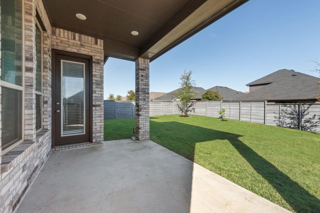 7001 Spring Park Drive Little Elm, TX 76227 - Photo 36 of 38 a view of a house with a yard and garage