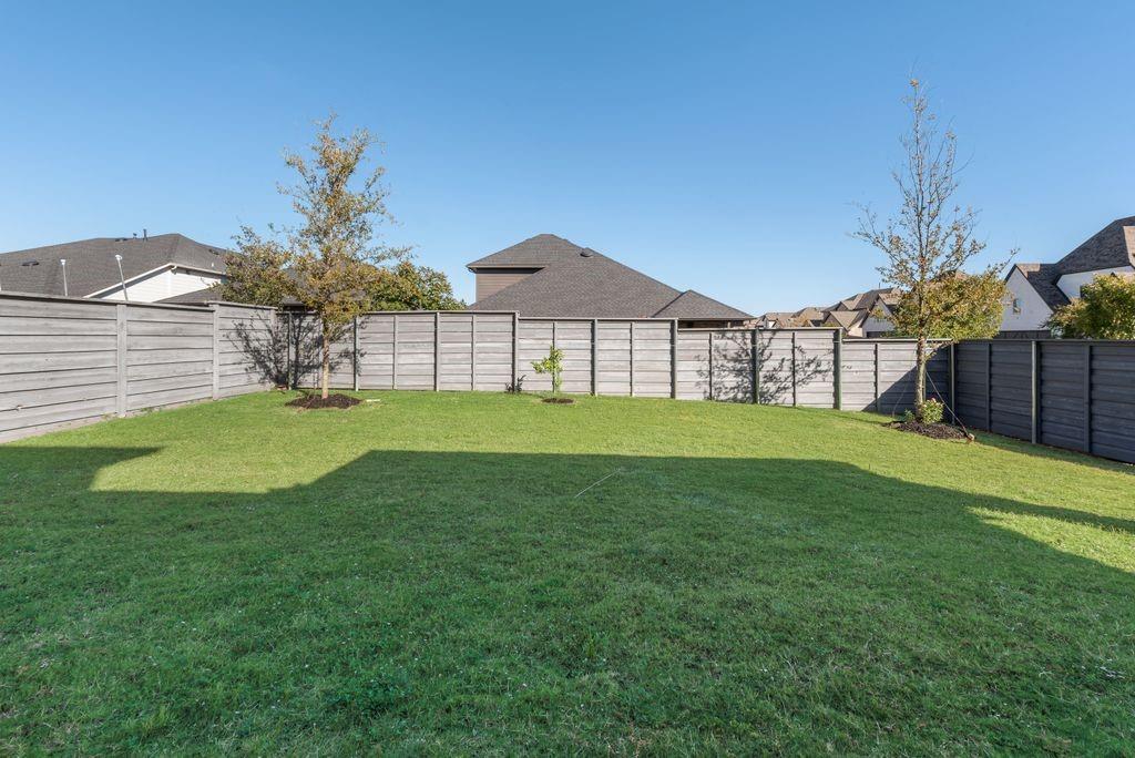 7001 Spring Park Drive Little Elm, TX 76227 - Photo 37 of 38 a front view of a house with garden