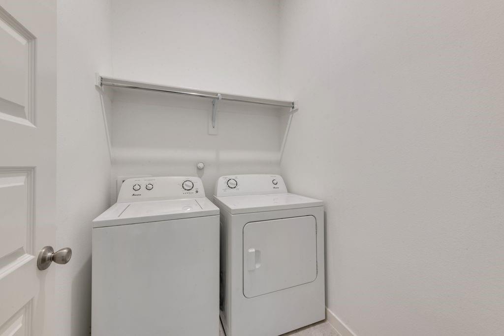 7001 Spring Park Drive Little Elm, TX 76227 - Photo 8 of 38 a utility room with dryer and washer