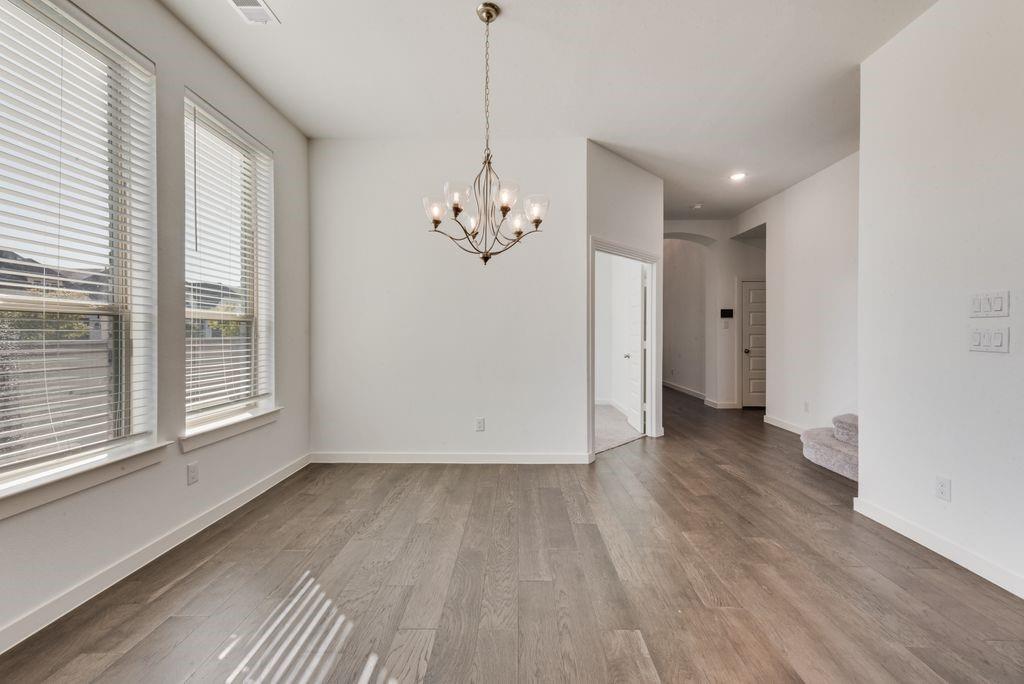 7001 Spring Park Drive Little Elm, TX 76227 - Photo 9 of 38 a view of a room with wooden floor and windows