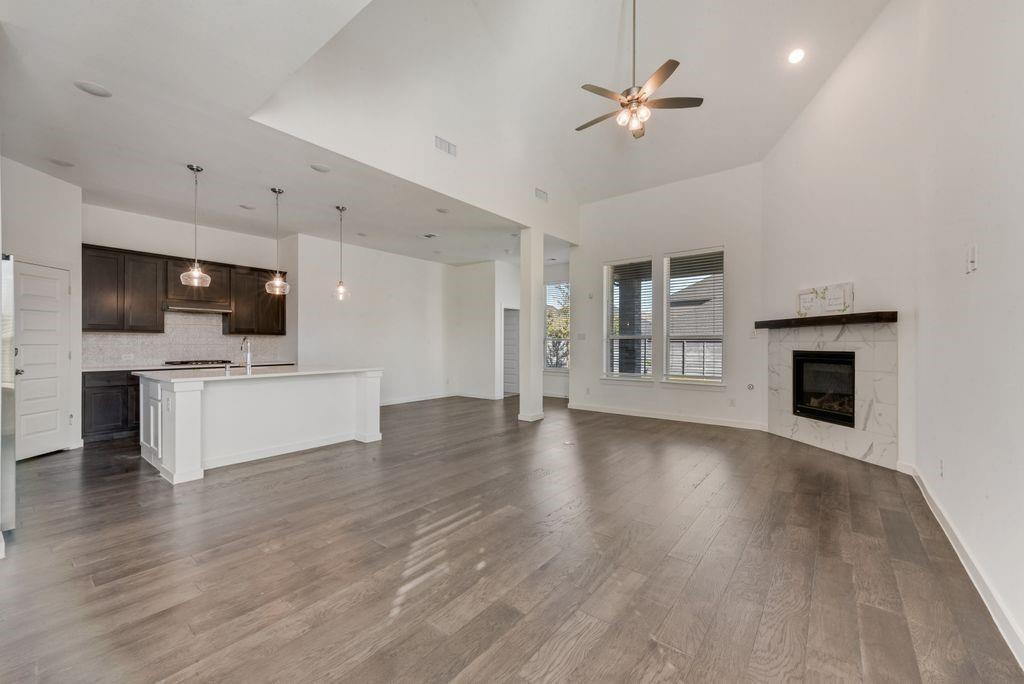 7001 Spring Park Drive Little Elm, TX 76227 - Photo 10 of 38 a view of a kitchen with a sink a kitchen a fireplace and a window