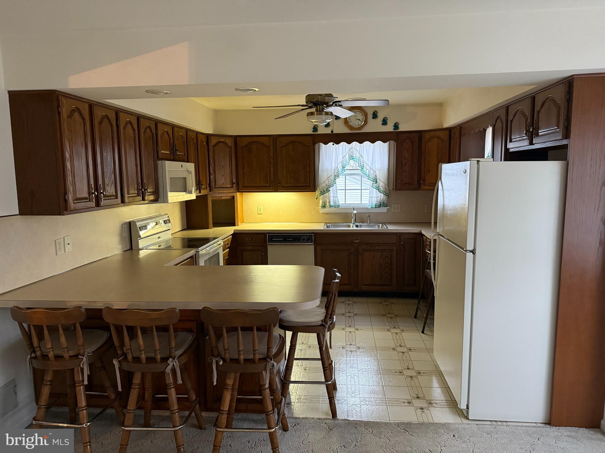 340 Estate Road Boyertown, PA 19512 - Photo 5 of 16 a kitchen with stainless steel appliances a table chairs and a refrigerator