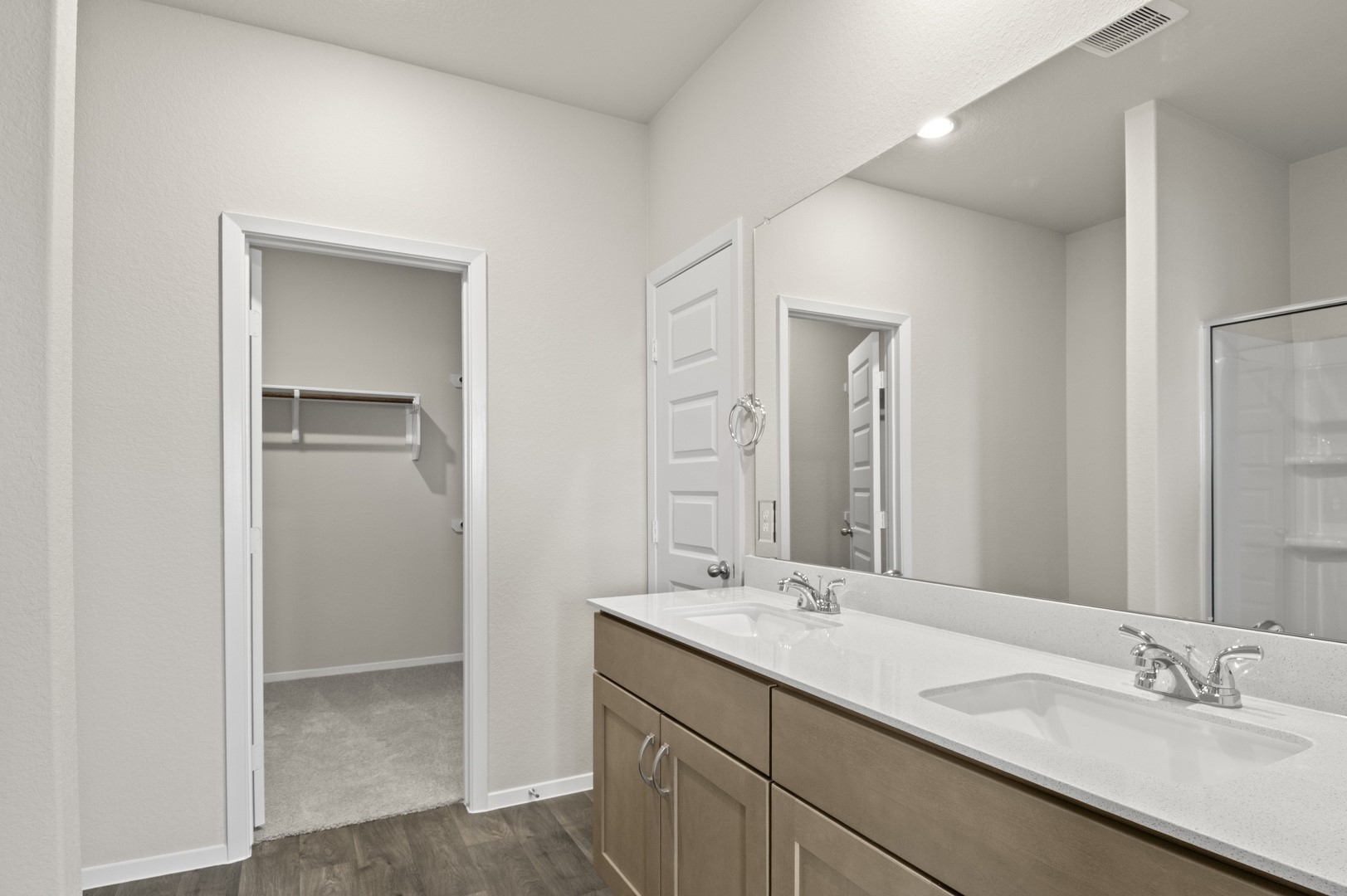 19222 Trinity Terrace Ln Spring Spring, TX 77379 - Photo 9 of 18 *Representative photo* Dual vanities with generous countertop space and abundant storage make daily routines effortless, while thoughtfully placed lighting ensures a warm, inviting glow throughout the space.