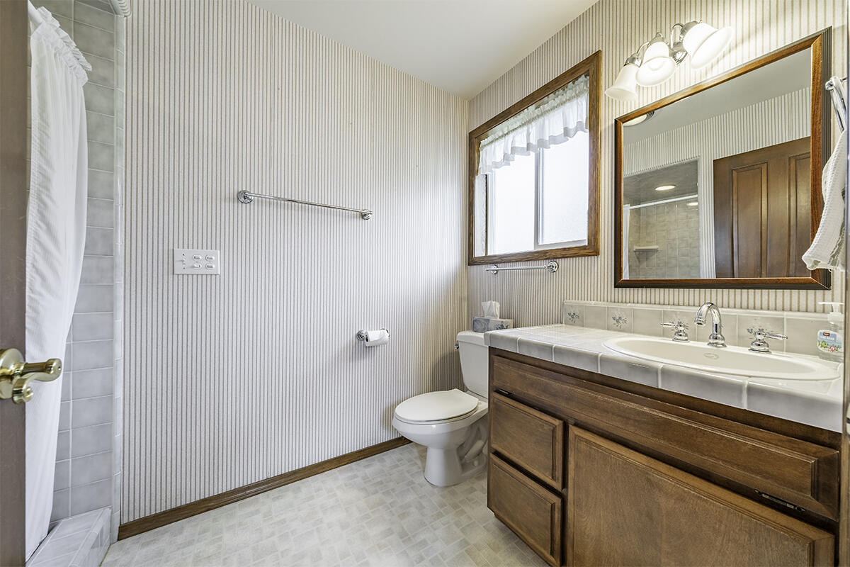 7255-7277 Upper Applegate Road Jacksonville, OR 97530 - Photo 25 of 36 a bathroom with a granite countertop sink toilet and mirror