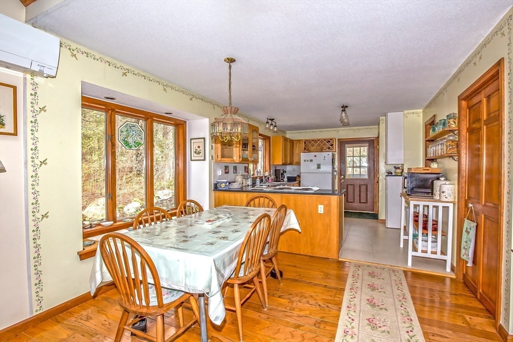 32 Woodchuck Hollow Road Tolland, MA 01034 - Photo 12 of 41 a dining room with furniture a chandelier and wooden floor