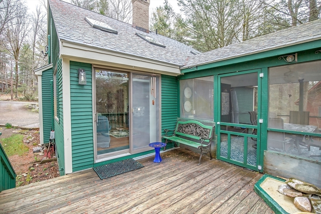 32 Woodchuck Hollow Road Tolland, MA 01034 - Photo 21 of 41 a view of a house with a large window and wooden fence