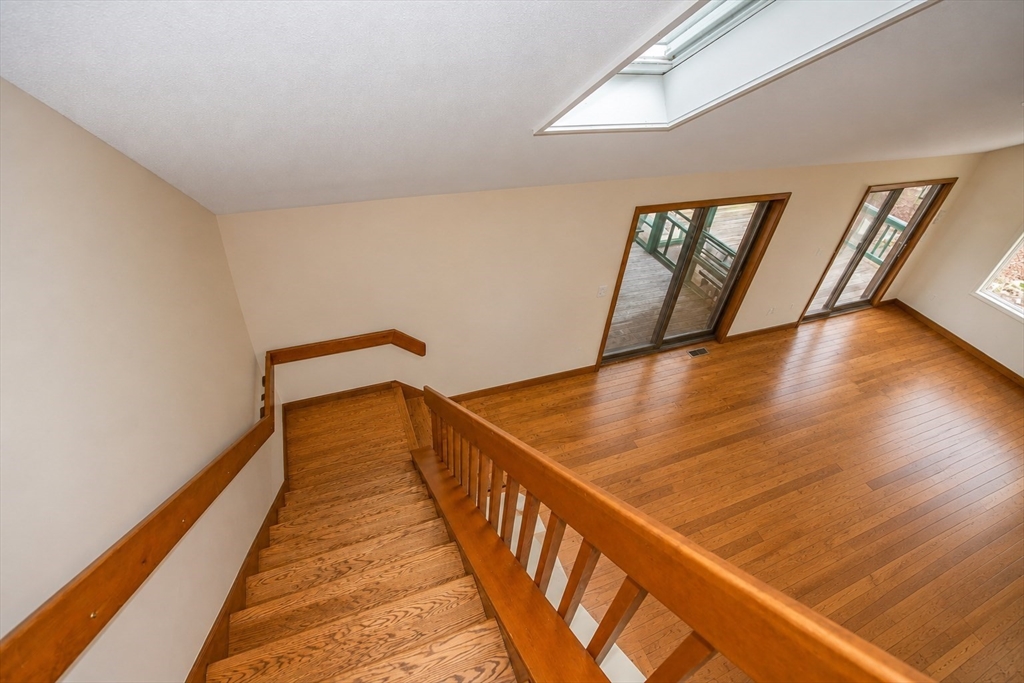 32 Woodchuck Hollow Road Tolland, MA 01034 - Photo 22 of 41 a view of a hallway with wooden floor and stairs