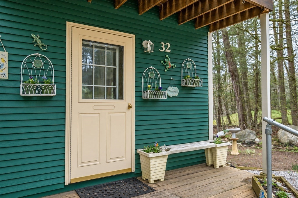 32 Woodchuck Hollow Road Tolland, MA 01034 - Photo 3 of 41 a front view of a house with a garden