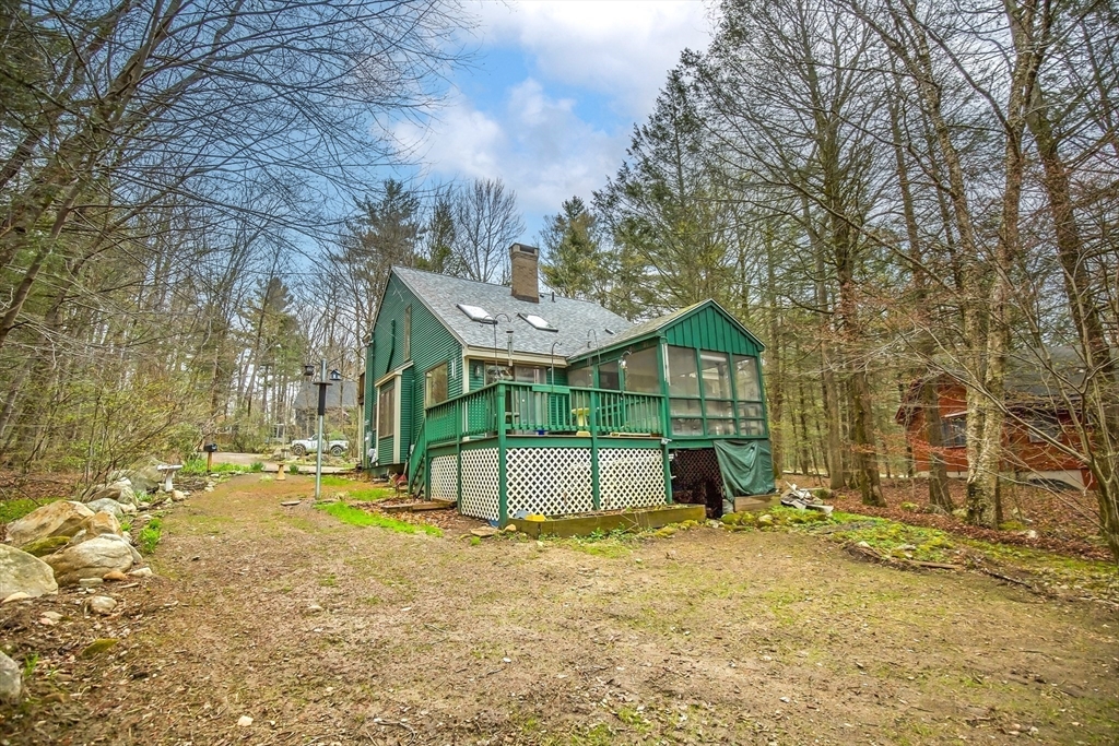 32 Woodchuck Hollow Road Tolland, MA 01034 - Photo 5 of 41 a house that has a tree in front of it