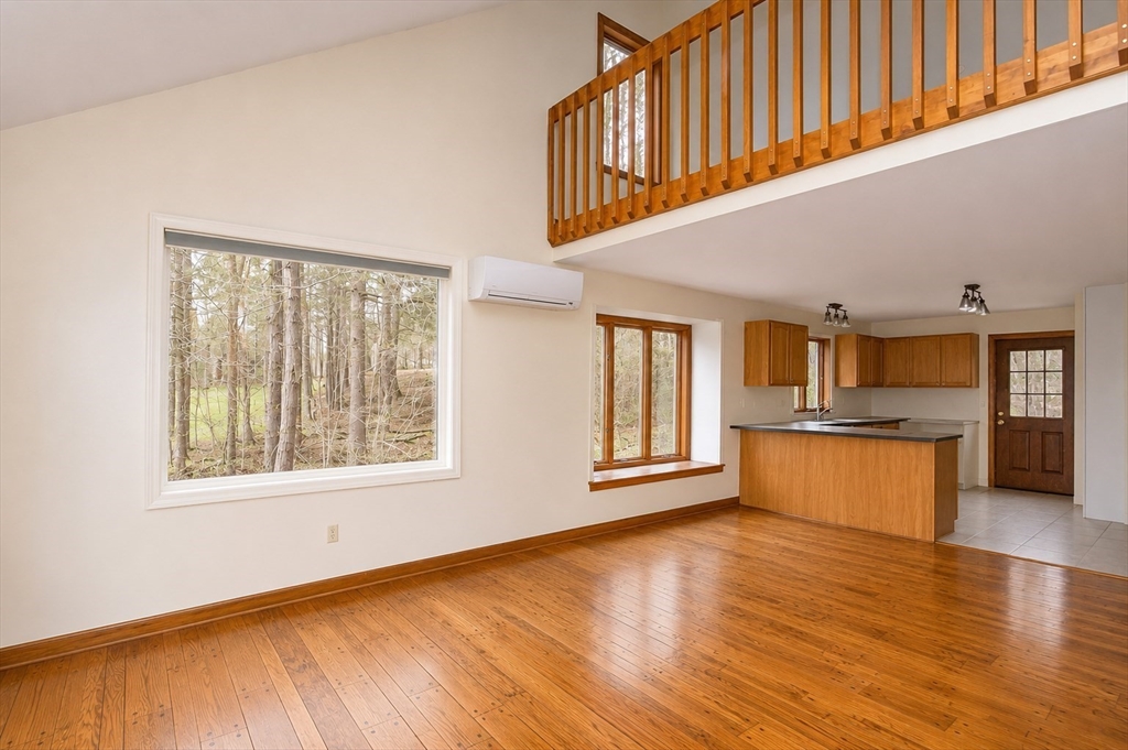 32 Woodchuck Hollow Road Tolland, MA 01034 - Photo 8 of 41 a view of an empty room with a window and wooden floor