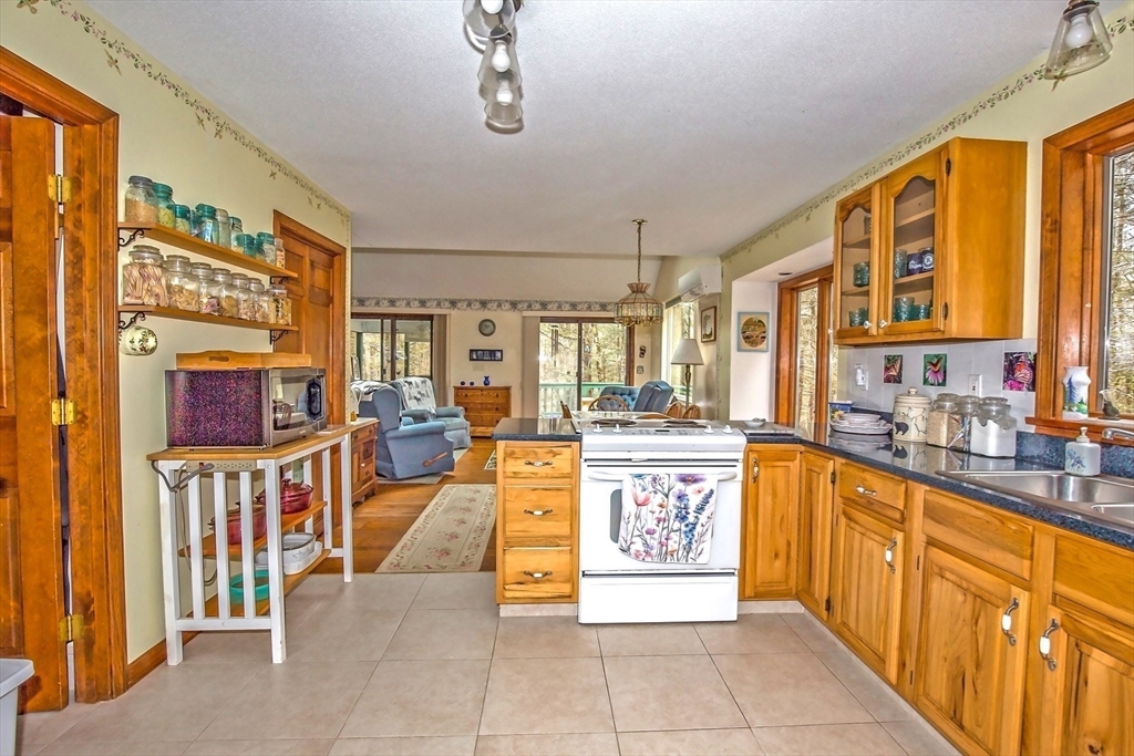32 Woodchuck Hollow Road Tolland, MA 01034 - Photo 10 of 41 a large kitchen with stainless steel appliances granite countertop a stove and cabinets