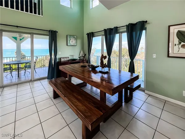a living room with furniture a flat screen tv and a kitchen view