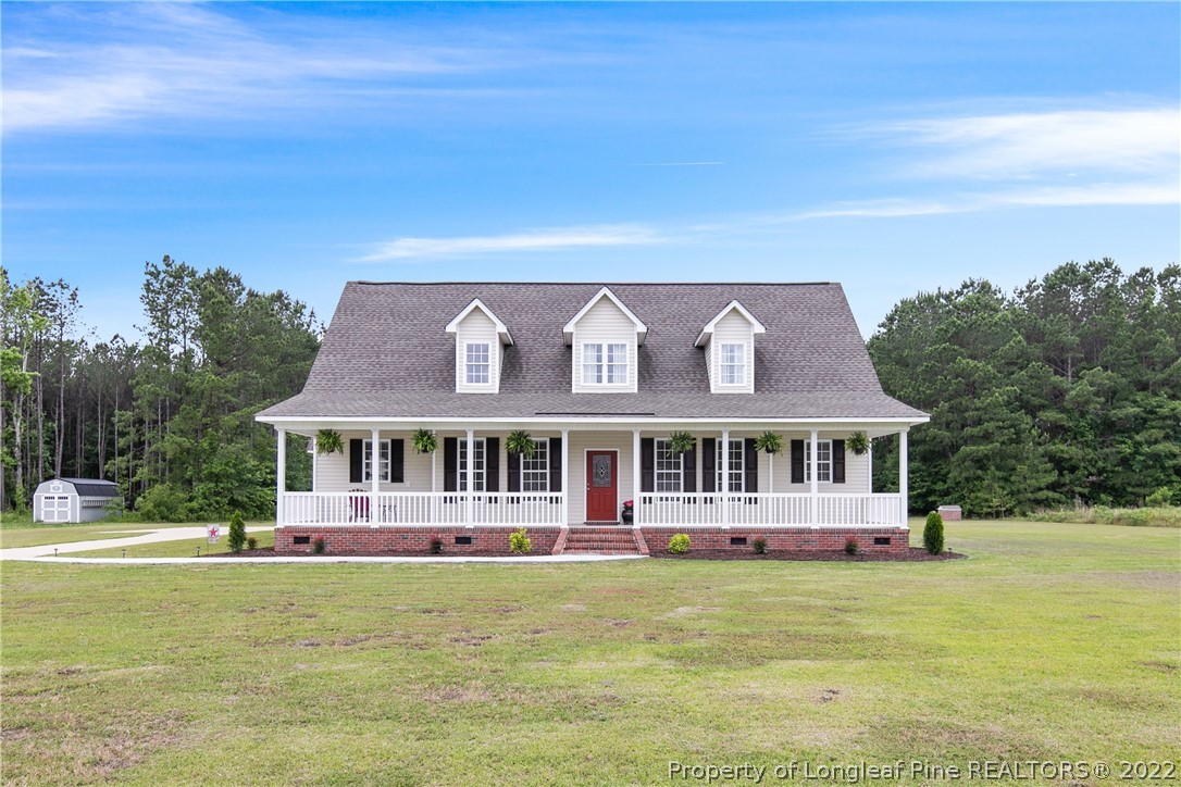 a view of a house with garden and trees