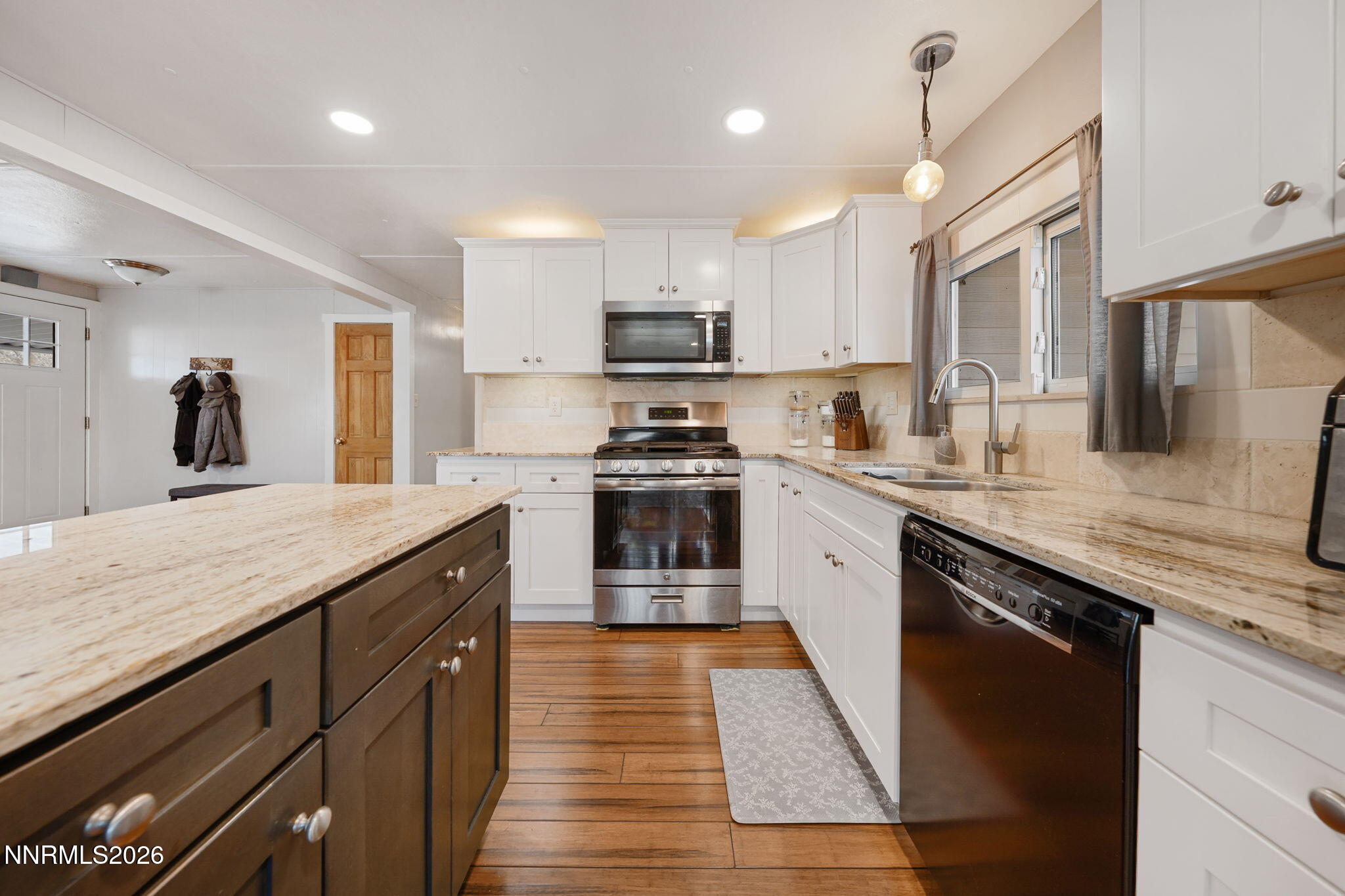 220 Aristocrat Way Reno, NV 89506 - Photo 21 of 35 a kitchen with stainless steel appliances granite countertop a stove top oven a sink and dishwasher