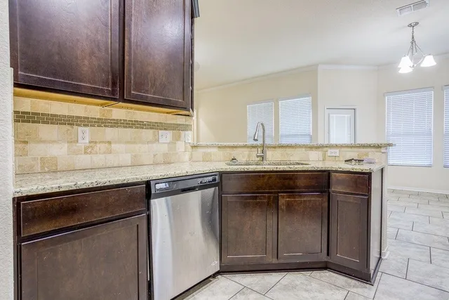 a kitchen with granite countertop cabinets stainless steel appliances and a counter space