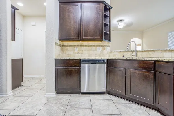 a kitchen with granite countertop a sink and cabinets