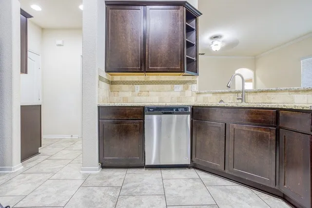 a kitchen with granite countertop a sink and cabinets