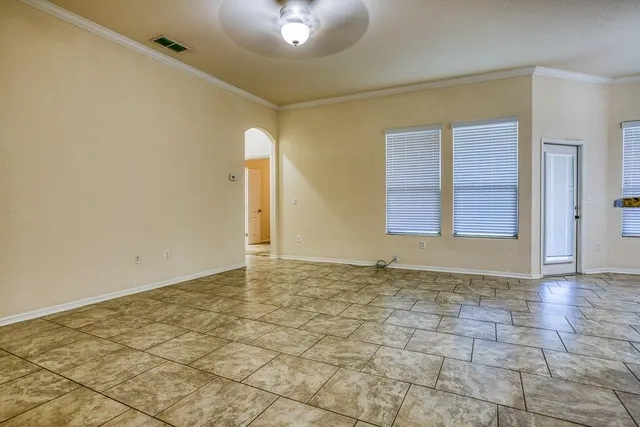 a view of an empty room with a chandeliers