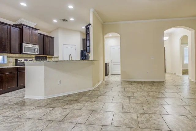 a view of a kitchen with kitchen island wooden floor and window