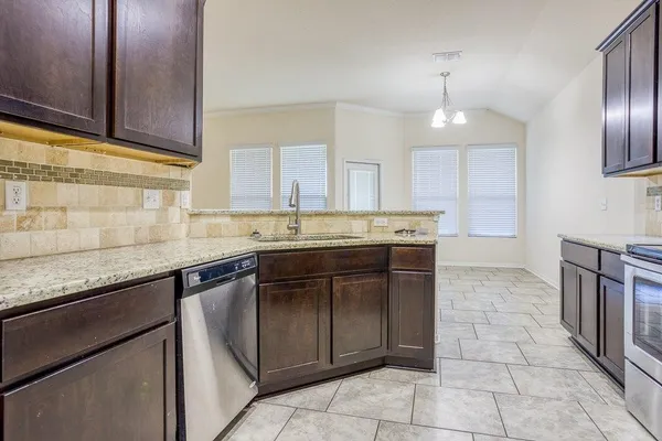 a kitchen with a sink window and cabinets