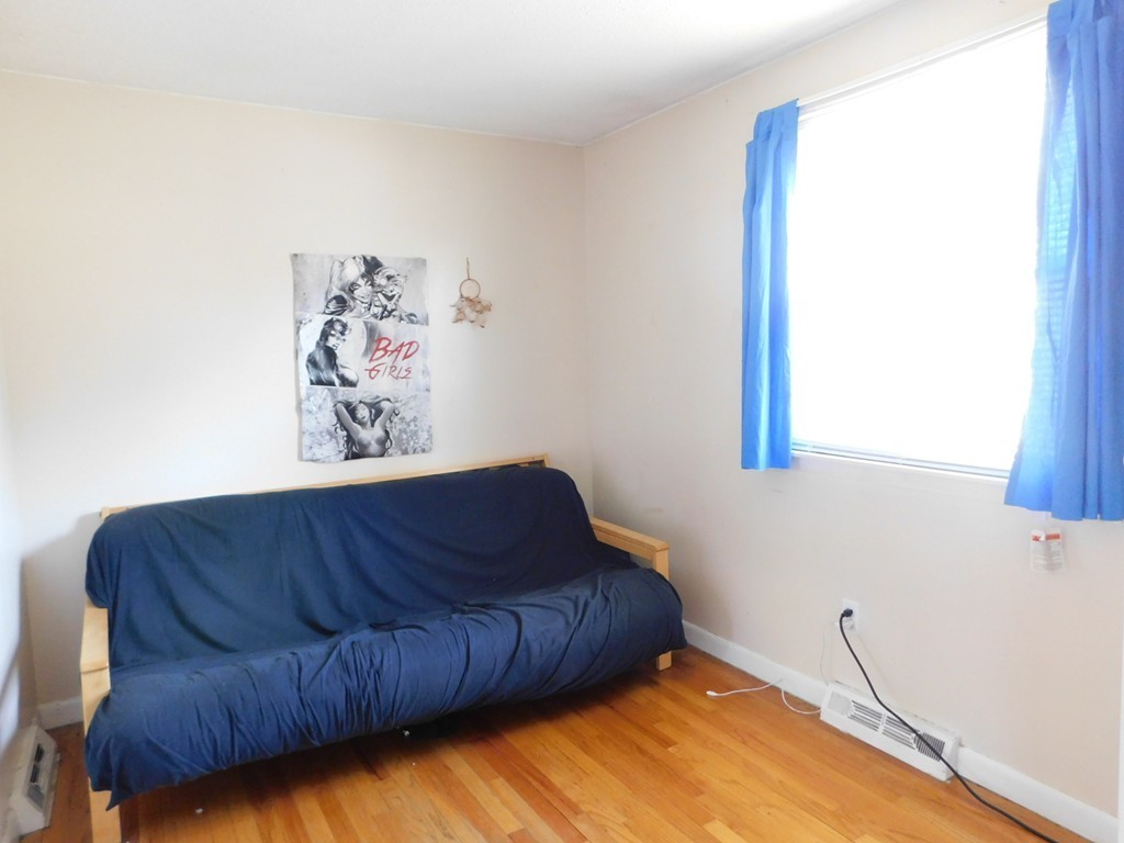96 Laurence Street Springfield, MA 01104 - Photo 11 of 21 a living room with a couch and a window