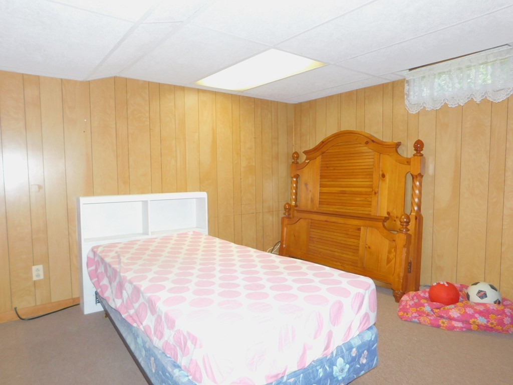 96 Laurence Street Springfield, MA 01104 - Photo 15 of 21 a bedroom with a bed and a painting on the wall