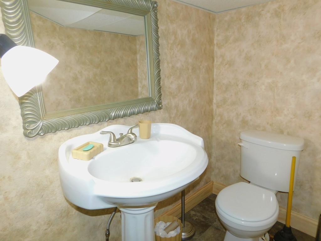 96 Laurence Street Springfield, MA 01104 - Photo 17 of 21 a bathroom with a sink a toilet and mirror