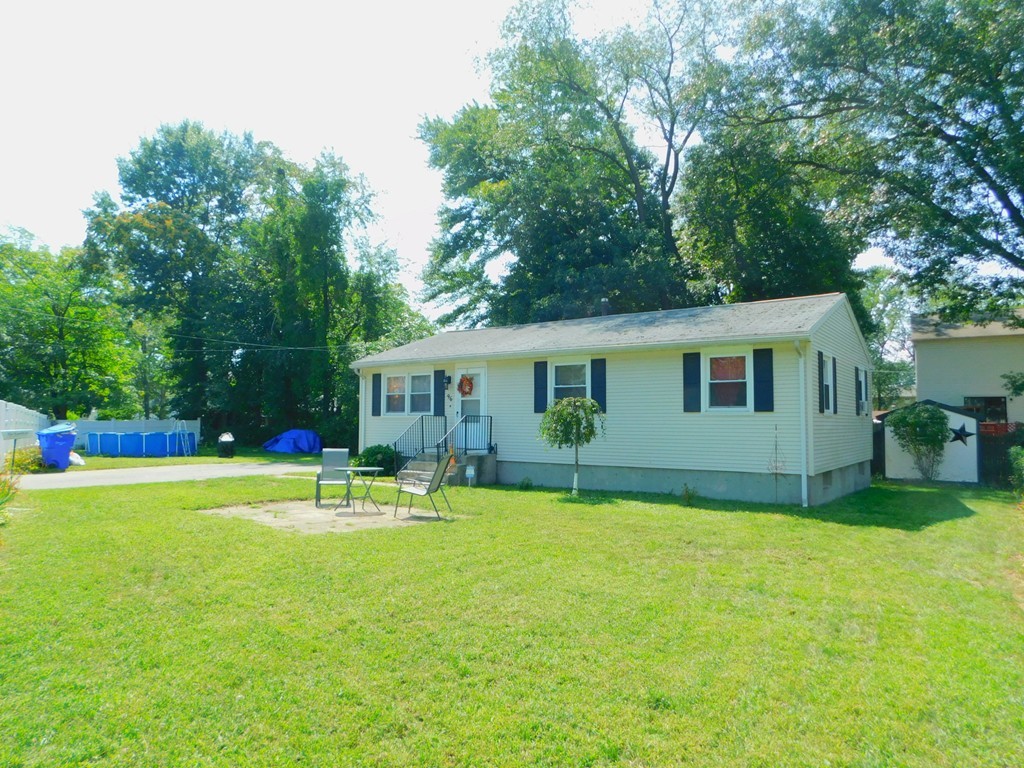 96 Laurence Street Springfield, MA 01104 - Photo 2 of 21 a backyard of a house with barbeque oven table and chairs